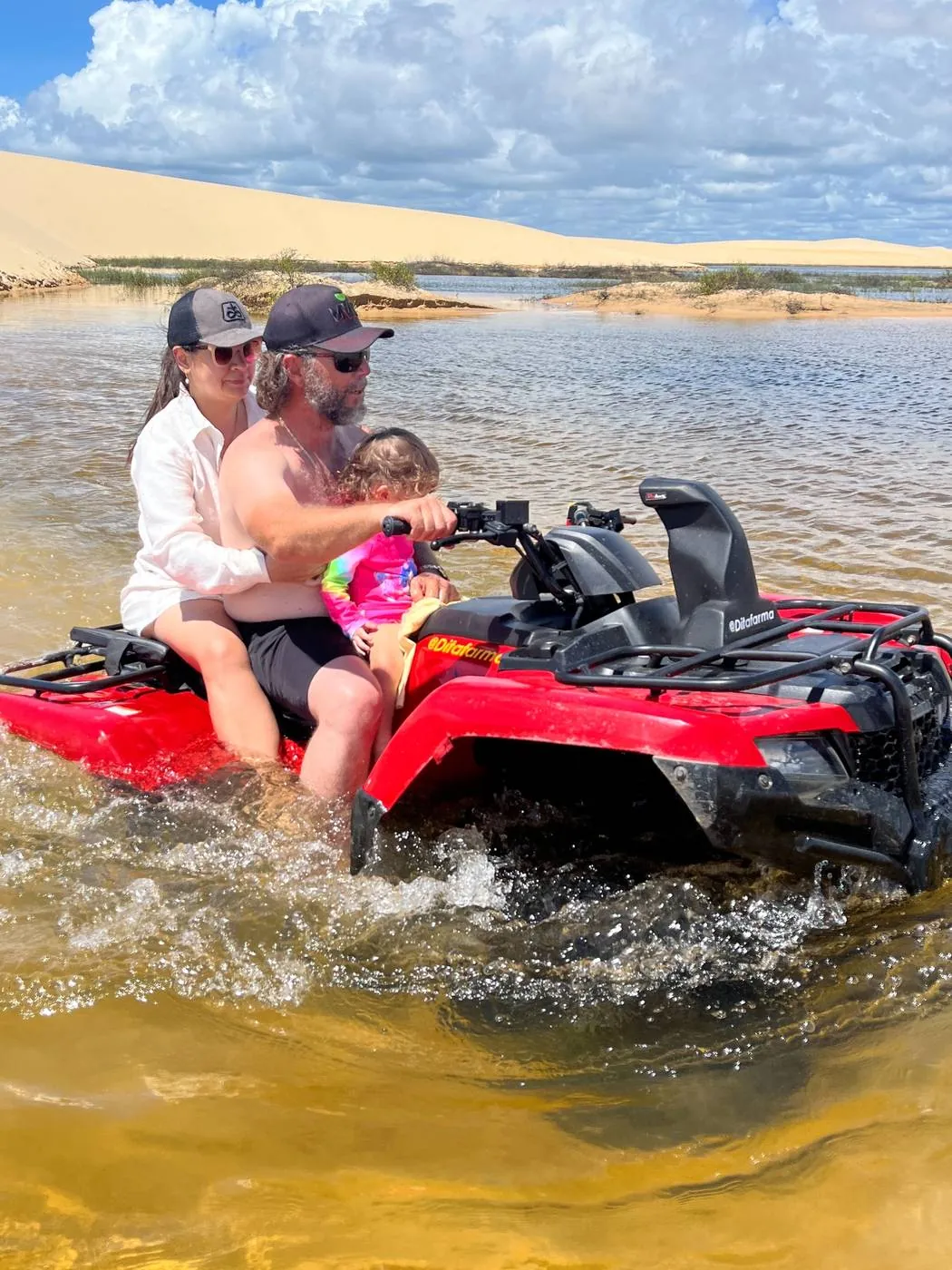 ATV crossing a river between dunes in the Pequenos Lençóis